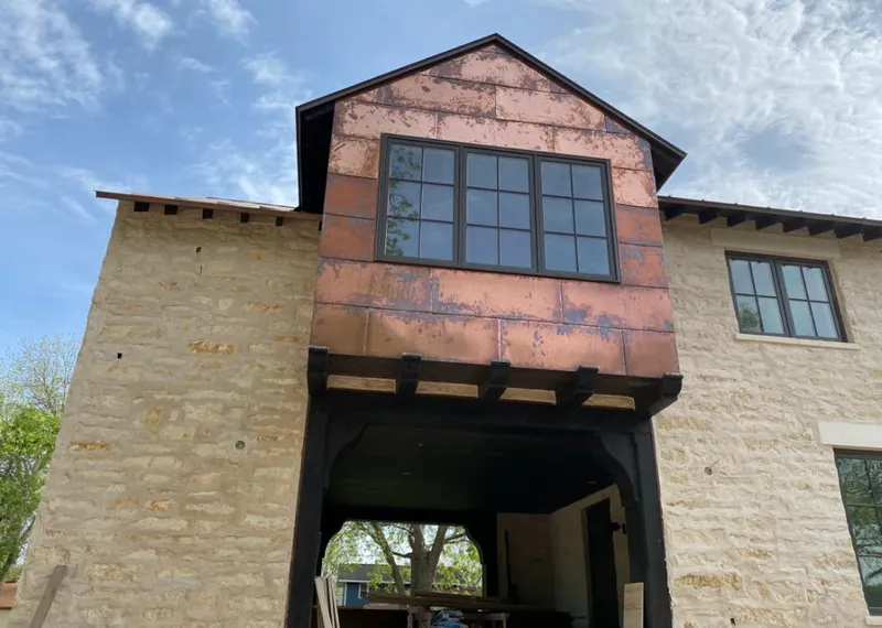 Copper metal panel facade on a stone building for Skylight Installation in Brevard