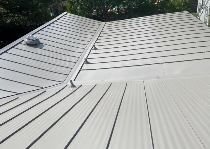 Solar attic fan installed on a metal roof for Roof Ventilation in Brevard